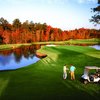 A beautiful fall view of a green surrounded by water at Brier Creek Country Club