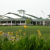 A view of a green and the clubhouse at Jacksonville Country Club