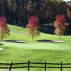 A view of a green protected by sand traps at High Meadows Golf & Country Club