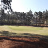 A sunny day view of a green at Pinewild Country Club of Pinehurst