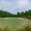 A view of a green protected by bunkers at Foxfire Resort & Golf Club